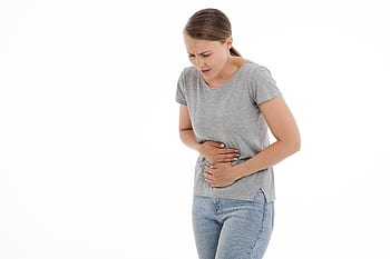 woman holding stomach, tiredness and bloating after eating