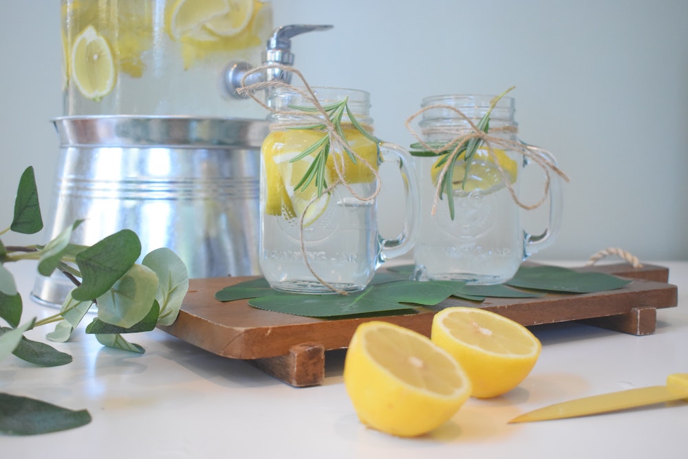 2 glasses of water with lemons in. Drinking fresh water can help keep mucus membranes hydrated
