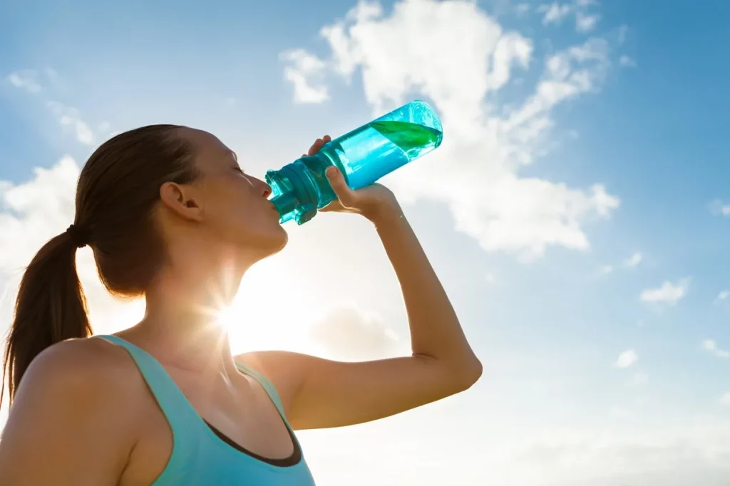 TASK-Systematic Kinesiology blog-Hydration and electrolyte balance-woman drinking water
