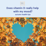 Autumn leaves framing a heart-shaped patch of sky, vitamin D and mood in autumn